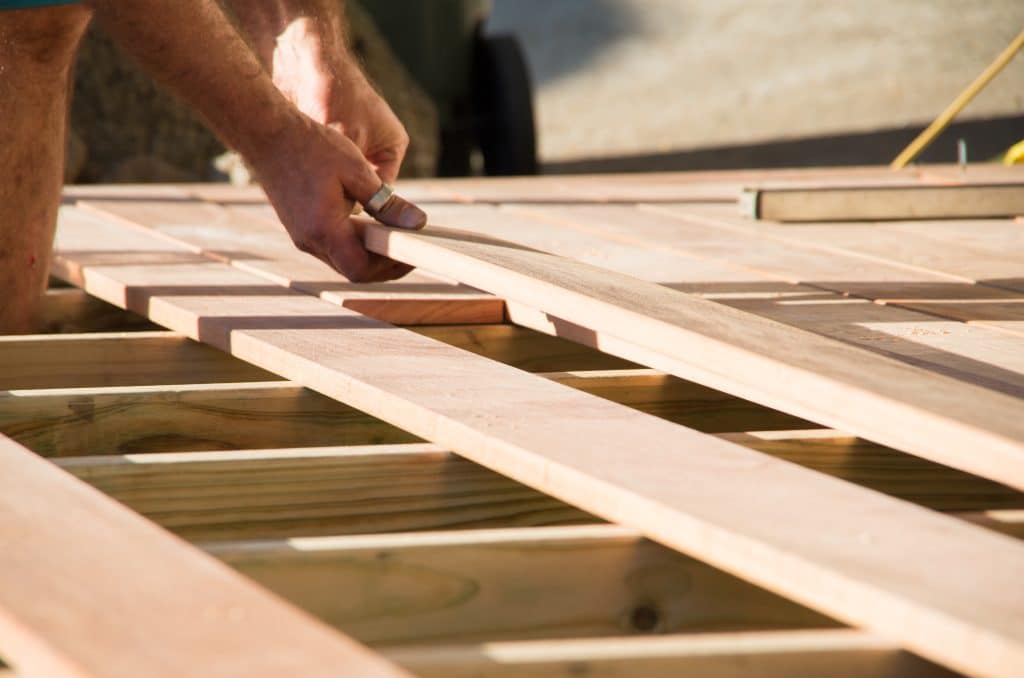 Backyard deck and pergola being built in dry winter conditions to save on renovation and extensions costs.